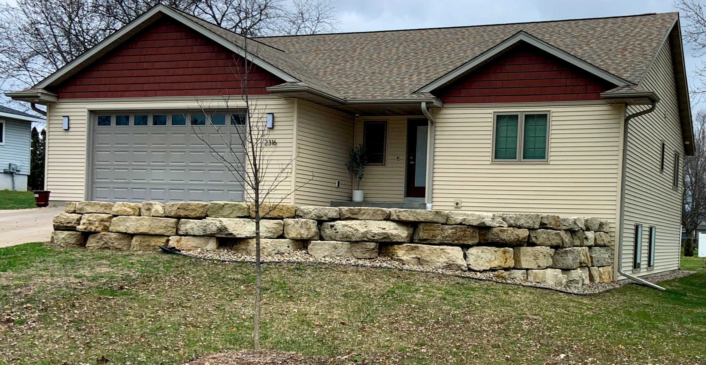 Stone retaining wall in a grassy field
